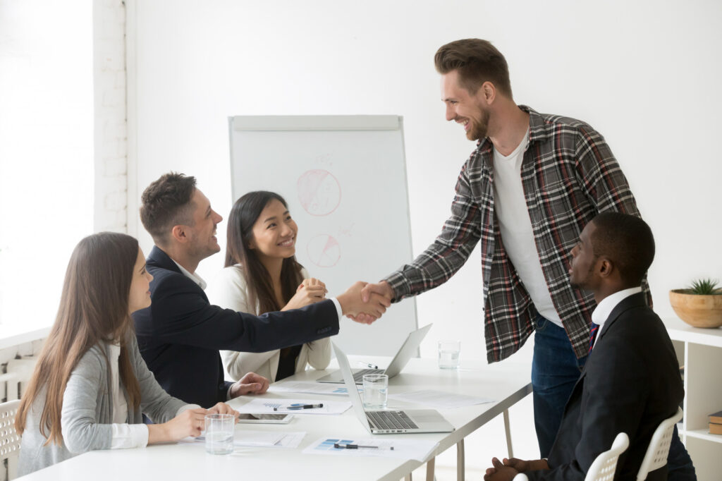Handshake symbolizing successful partnership between The CodeShooters and a client